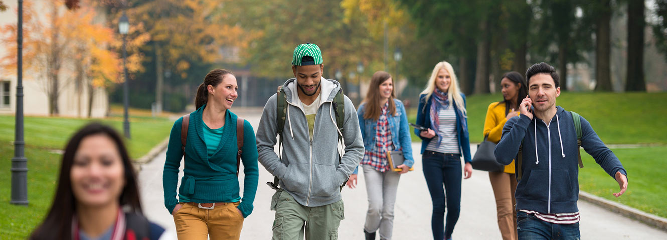 Group of college kids walking on campus.